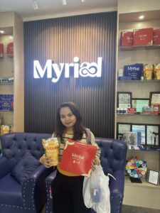 Young Woman holding Myriad Skincare Set Box and Melonia Pouch