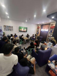 A group of people gathered around inside Myriad Office