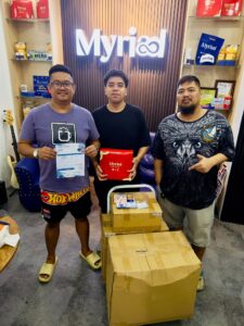 3 Men posing for a photo inside Myriad Center